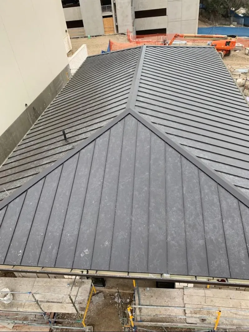 Commercial metal roof construction with crane equipment in Eastvale